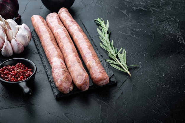 Traditional raw beef sausages, on black background