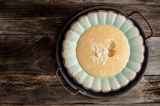 Traditional recipe of Du Barry soup cauliflower in bowl on wooden background space for text top view