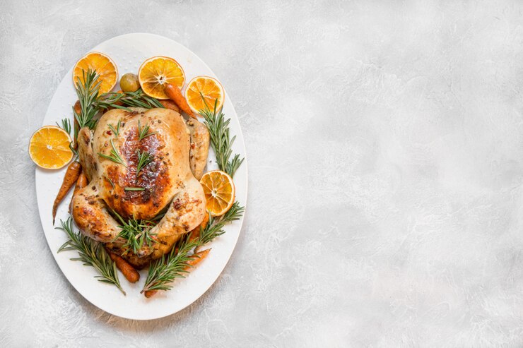 Traditional roasted chicken on light table