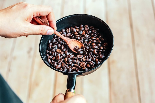 Traditional roasting of coffee bean in barista hand xA