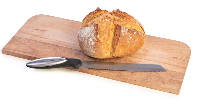 Traditional round bread with cutting board on a white surface