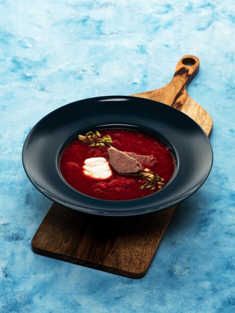 Traditional Russian borscht with sour cream on the plate. Flat lay. Top view