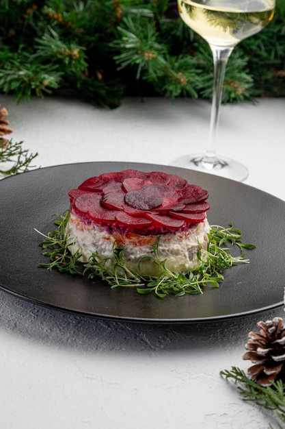 Traditional russian dish herring under a fur coat. on a white\
christmas background