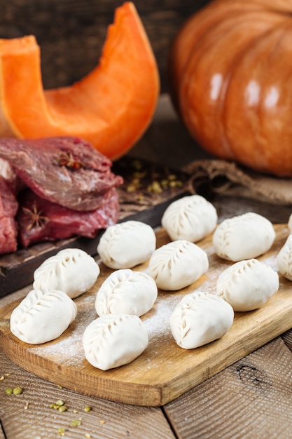 Traditional Russian dish of manti dumplings with meat and pumpkin