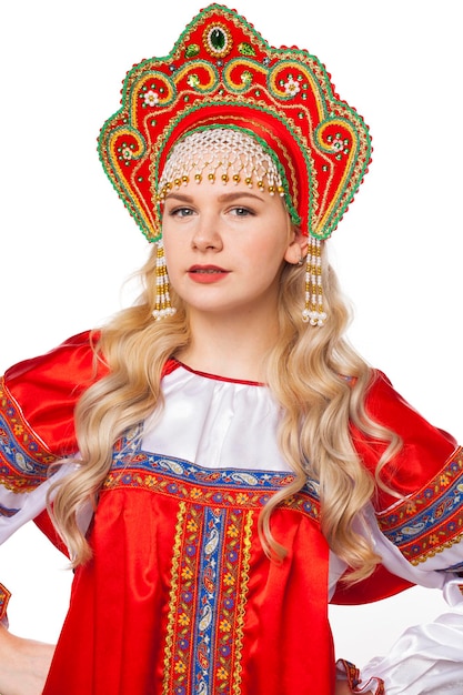 Traditional russian folk costume portrait of a young beautiful blonde girl in red dress isolated on white background