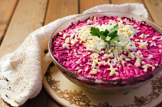 Traditional Russian herring on a white plate with parsley