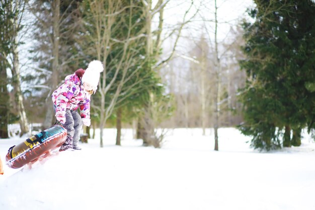 Traditional Russian holiday in early spring. Seeing off winter. Mardi gras. Family with children in the winter in the park.