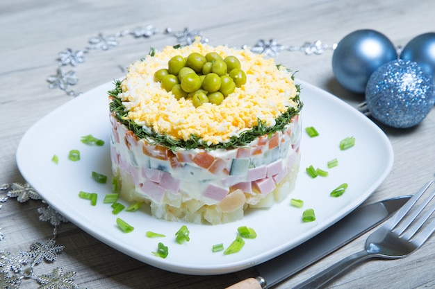 Traditional Russian olivier salad on a white plate