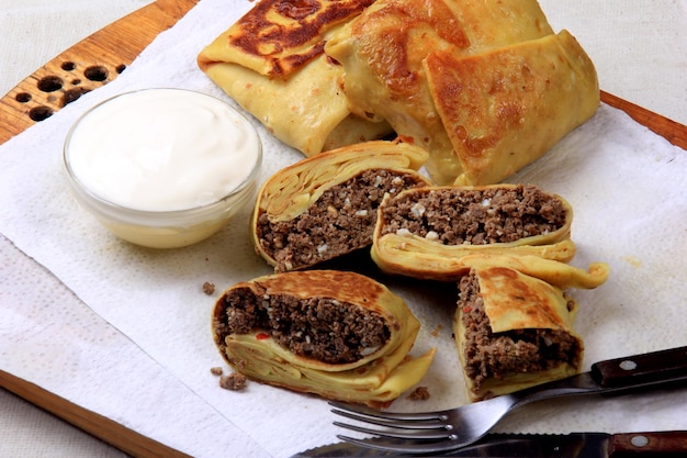 Traditional russian pancakes or blini with curd. Pancakes filled with minced heart or meat