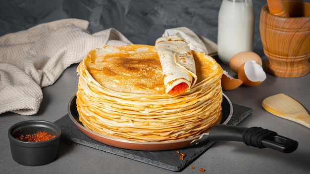 Traditional Russian pancakes with butter and red caviar