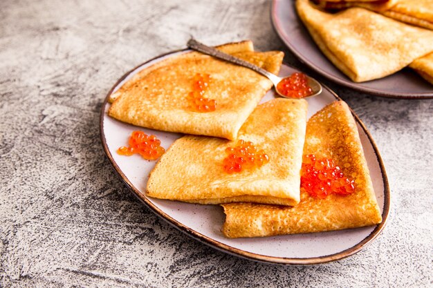 Traditional russian pancakes with red caviar