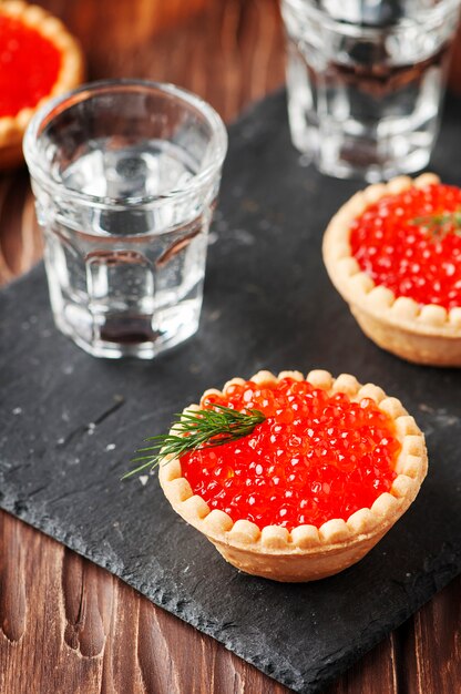 Traditional russian red caviare on the wooden table