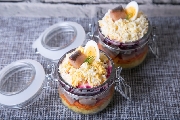 Traditional Russian salad from herring, beets, potatoes, carrots and eggs. 