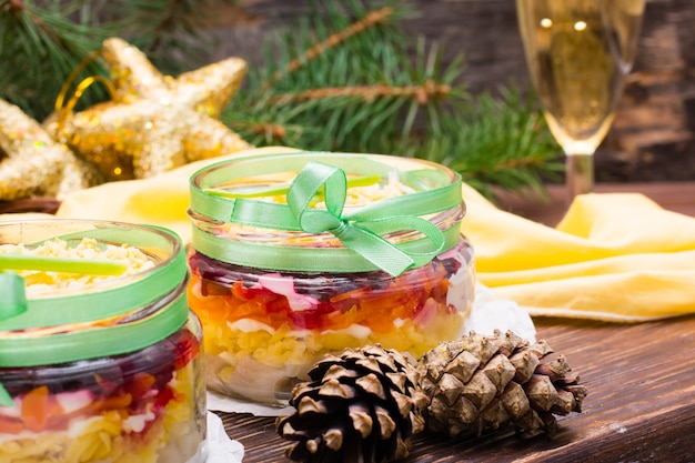 Traditional Russian salad, herring under a fur coat in bowls 