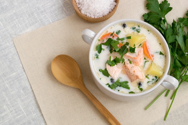 Traditional salmon soup with vegetables and cream.