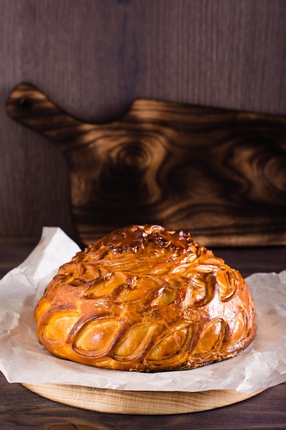 Traditional savory pie kurnik with chicken potatoes and rice Homemade baking Vertical view