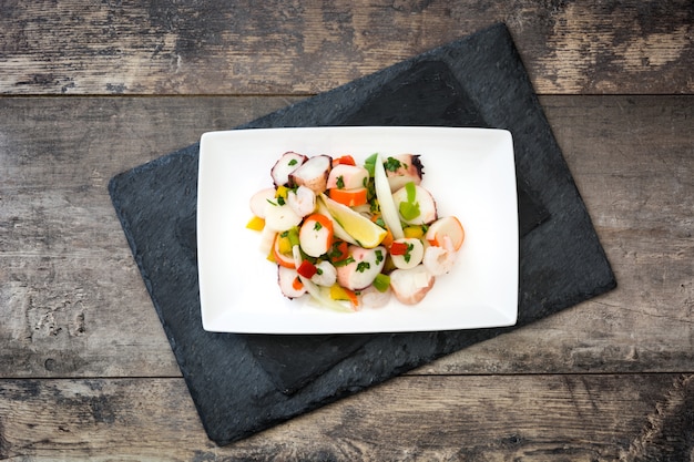 Traditional seafood ceviche from Peru on wooden table top view