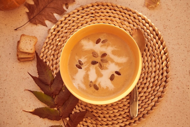 Traditional seasonal vegetarian healthy pumpkin cream soup with seeds and plantbased cream