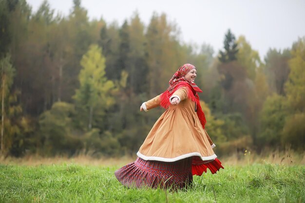 Traditional Slavic rituals in the rustic style. Outdoor in summer. Slavic village farm. Peasants in elegant robes.