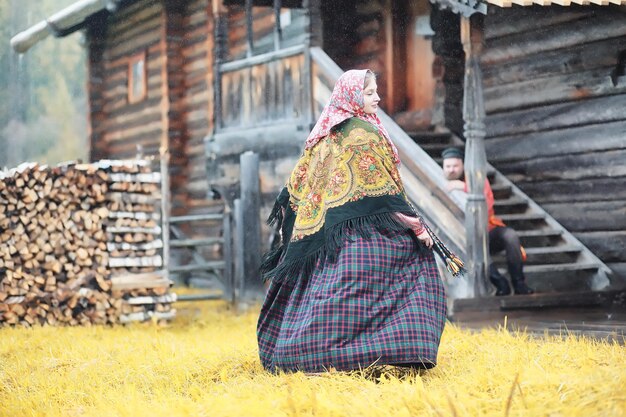 Traditional Slavic rituals in the rustic style. Outdoor in summer. Slavic village farm. Peasants in elegant robes.