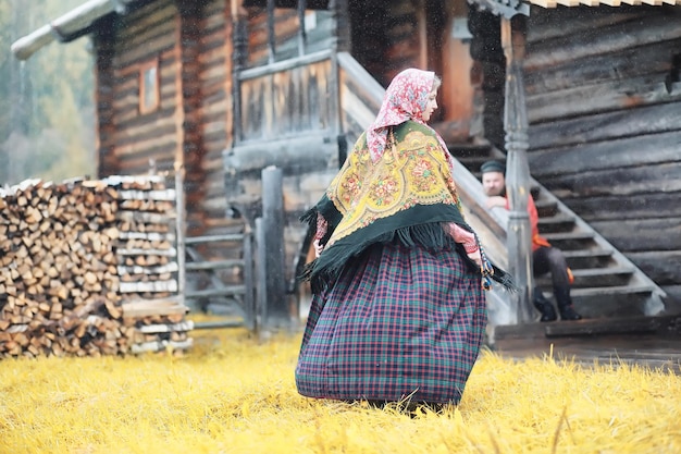 Traditional Slavic rituals in the rustic style. Outdoor in summer. Slavic village farm. Peasants in elegant robes.