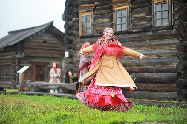 Traditional Slavic rituals in the rustic style. Outdoor in summer. Slavic village farm. Peasants in elegant robes.