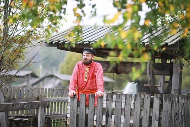 Photo traditional slavic rituals in the rustic style. outdoor in summer. slavic village farm. peasants in elegant robes.