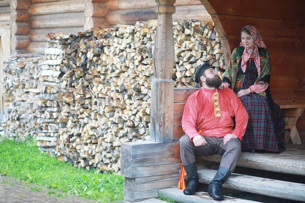 Traditional Slavic rituals in the rustic style Outdoor in summer Slavic village farm Peasants in elegant robes