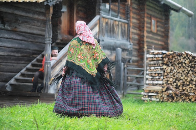 Traditional Slavic rituals in the rustic style Outdoor in summer Slavic village farm Peasants in elegant robes