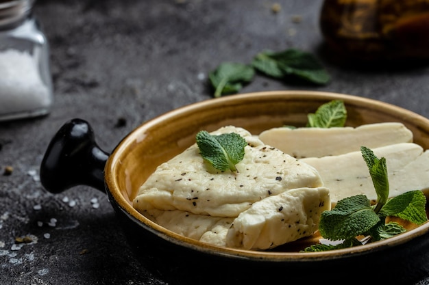 Traditional slices of cyprus halloumi cheese with mint healthy eco food Food recipe background Close up