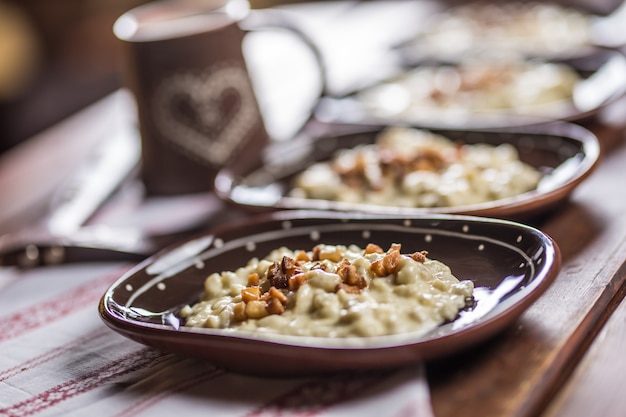 Traditional slovakian food Halusky with fried bacon and decoration.