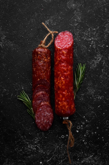 Traditional smoked salami sausage with spices Slice sausages Rosemary Top view Free space for your text