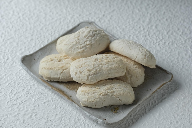 Traditional snack on white background Bolu Emprit made from tapioca flour sugar coconut milk and lime leaves