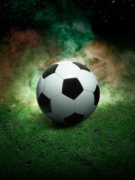 Traditional soccer ball on soccer field Close up view of soccer ball football on green grass with dark toned foggy background Selective focus