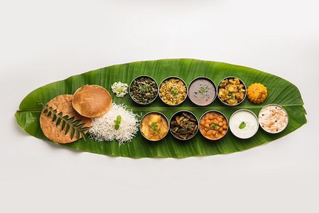 Traditional South Indian Meal or food served on big banana leaf, Food platter or complete thali.  selective focus