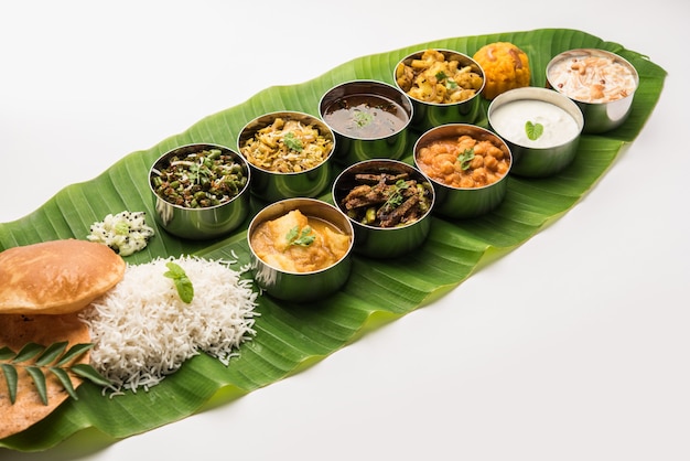 Traditional South Indian Meal or food served on big banana leaf, Food platter or complete thali.  selective focus