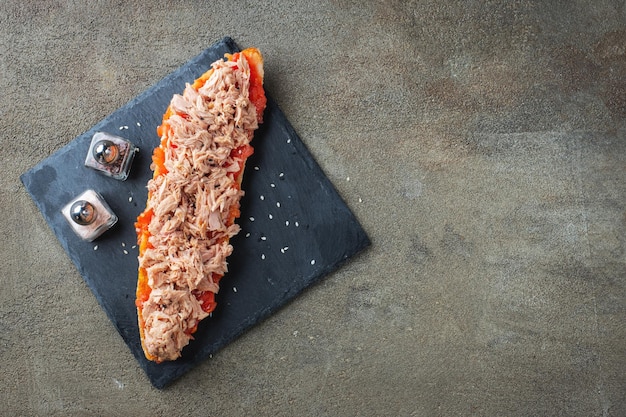 Traditional Spanish breakfast Tostada with different toppings on a dark background Top view with copy space