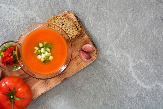 Traditional Spanish cold gazpacho soup on gray stone.