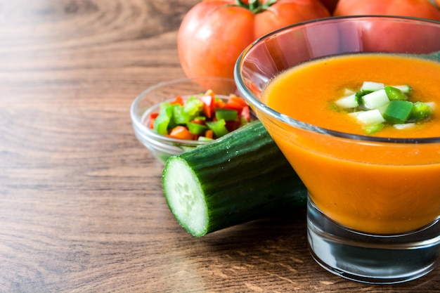 Traditional Spanish cold gazpacho soup and ingredients on wooden table copy space