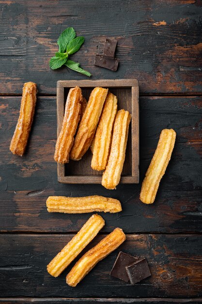 Traditional Spanish dessert churros with sugar and chocolate