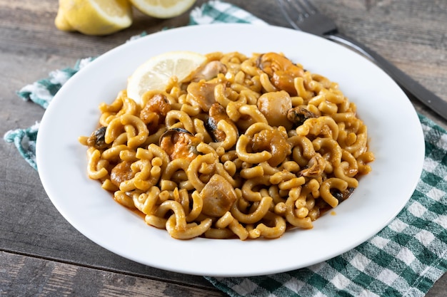 Traditional Spanish fideua Noodle paella on wooden table