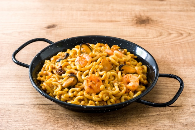 Traditional Spanish fideua, Noodle paella on wooden table