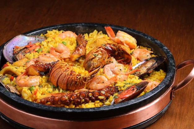 Traditional spanish paella with seafood on wooden table Spanish cuisine