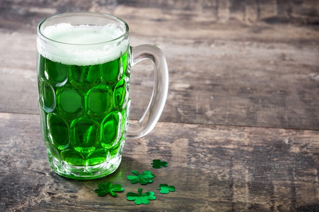 Traditional St Patrick's Day green beer on wooden table copy space