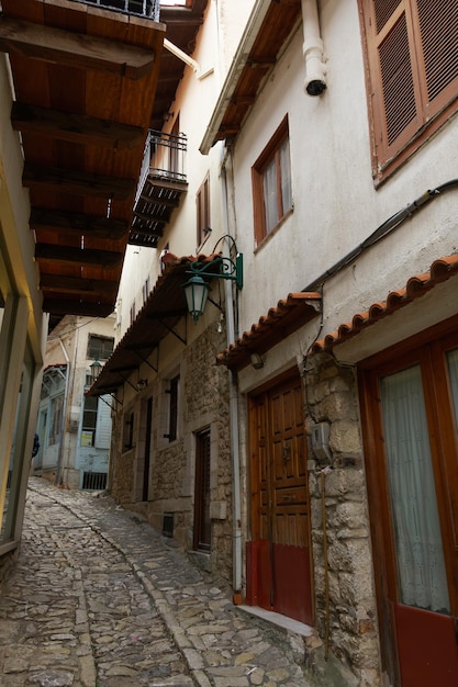 Traditional stone-built houses around empty cobblestone pavement n Arcadia Peloponnese Greece