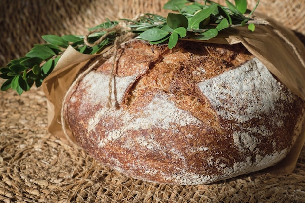 Traditional strawlined round bread at the christmas market sale\
of handicraft bread for the new year holidays