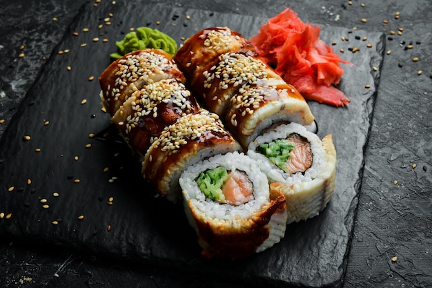 Traditional sushi rolls on a stone plate Closeup Sushi menu Japanese food