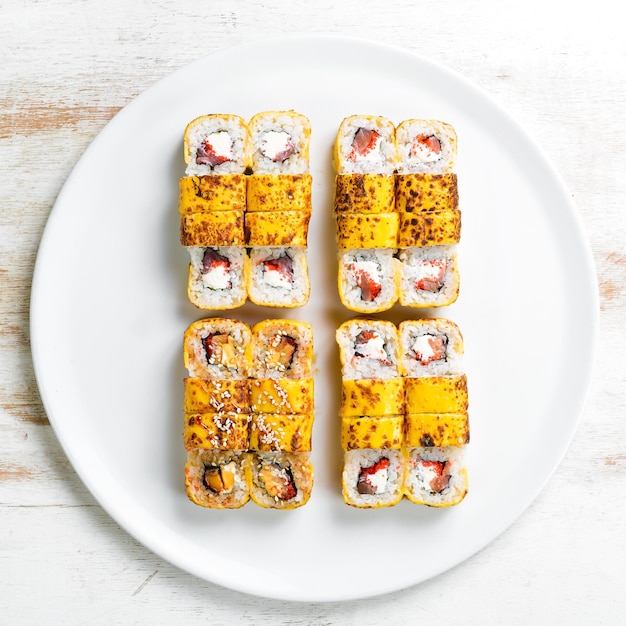 Traditional sushi rolls with cheese Japanese food Top view On a white background