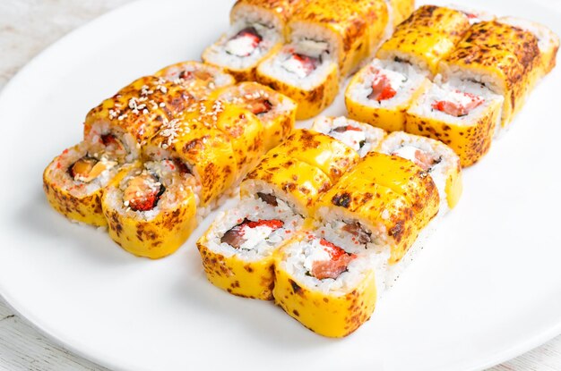 Traditional sushi rolls with cheese japanese food top view on a white background