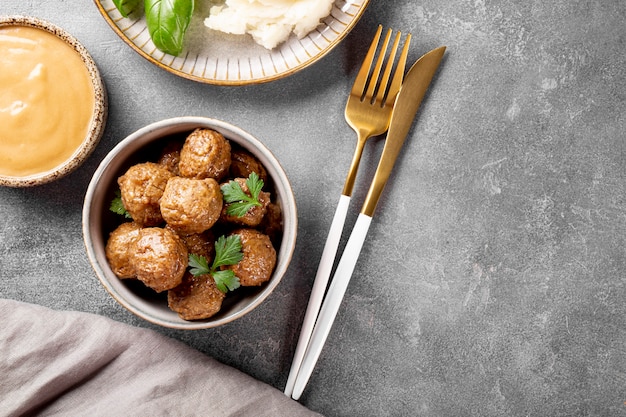 traditional swedish meatballs with creamy sauce and mashed potatoes on gray background top view